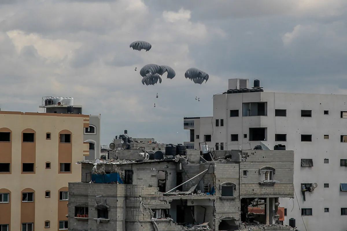 Humanitarian aid parcels attached to parachutes are airdropped from a military aircraft over the Gaza Strip on March 25, 2024. (-/AFP via Getty Images)