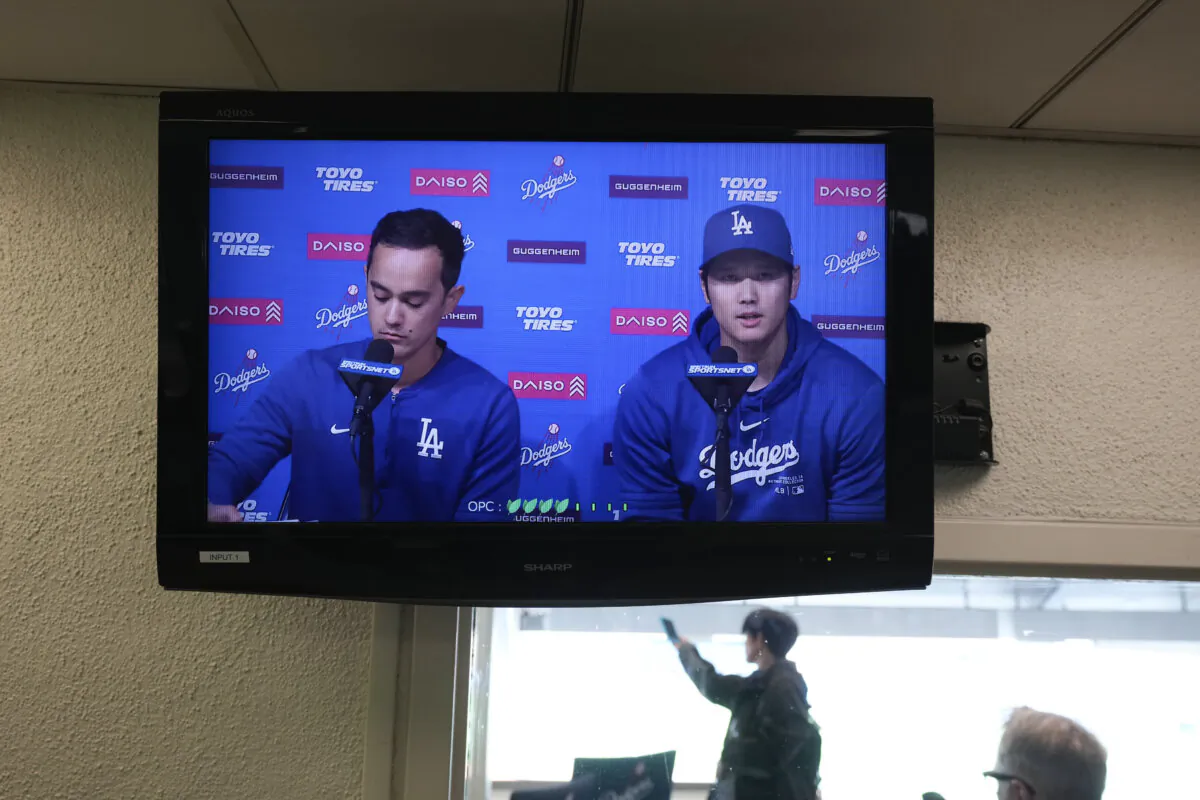 A video screen displays Los Angeles Dodgers' Shohei Ohtani (R) and interpreter Will Ireton during a news conference at Dodger Stadium in Los Angeles on March 25, 2024. (Jae C. Hong/AP Photo)