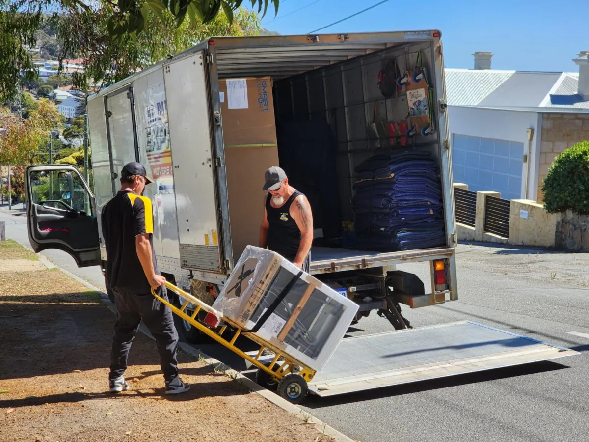 Two men unload a new dishwasher off a delivery truck in Albany, Western Australia, on March 25, 2024. (Susan Mortimer/The Epoch Times)