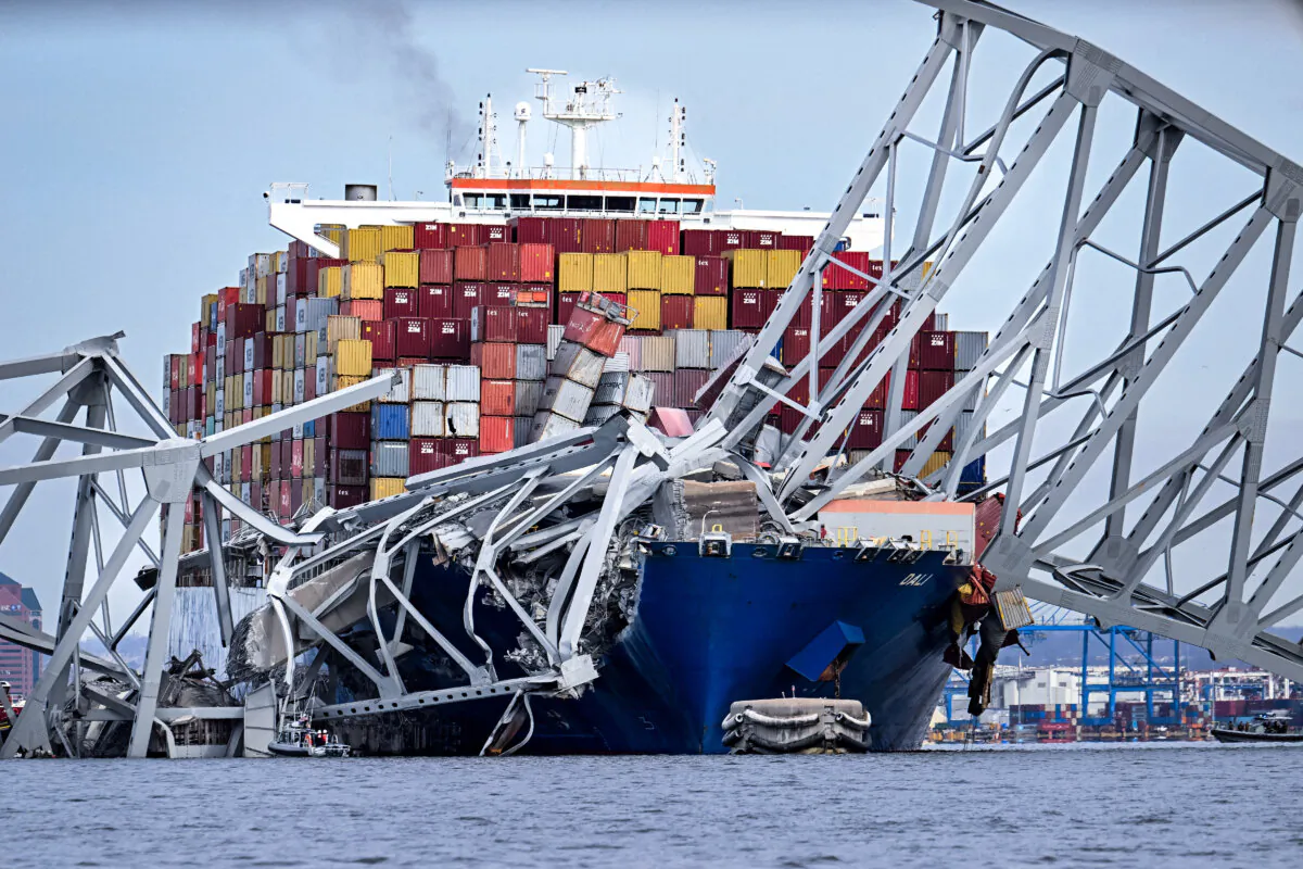 The steel frame of the Francis Scott Key Bridge sits on top of the container ship Dali after the bridge collapsed, in Baltimore on March 26, 2024. (Jim Watson/AFP via Getty Images)