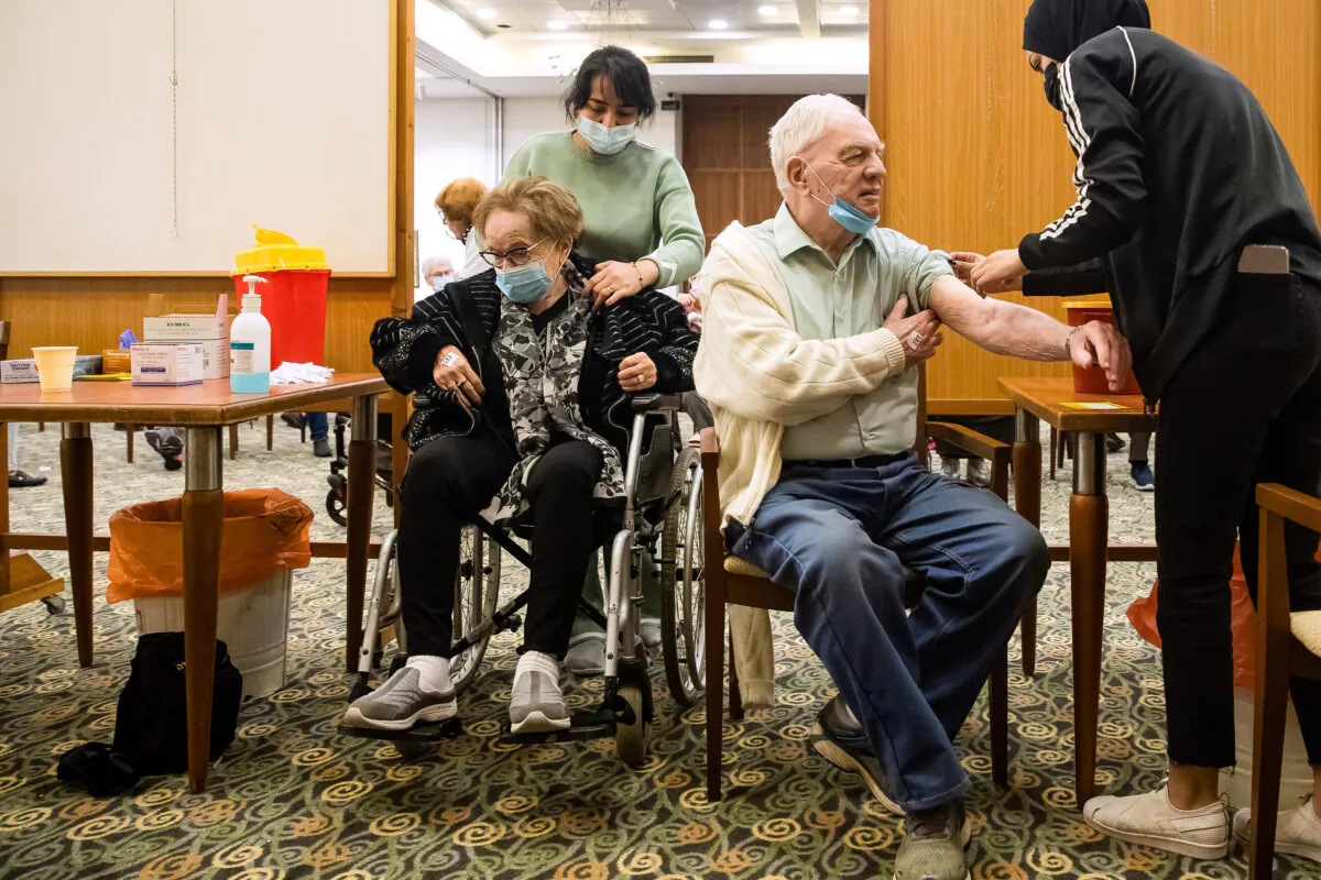 A couple receives a dose of the coronavirus vaccine at a nursing home in Tel Mond, Israel, on Jan. 6, 2022.

Amir Levy/Getty Images