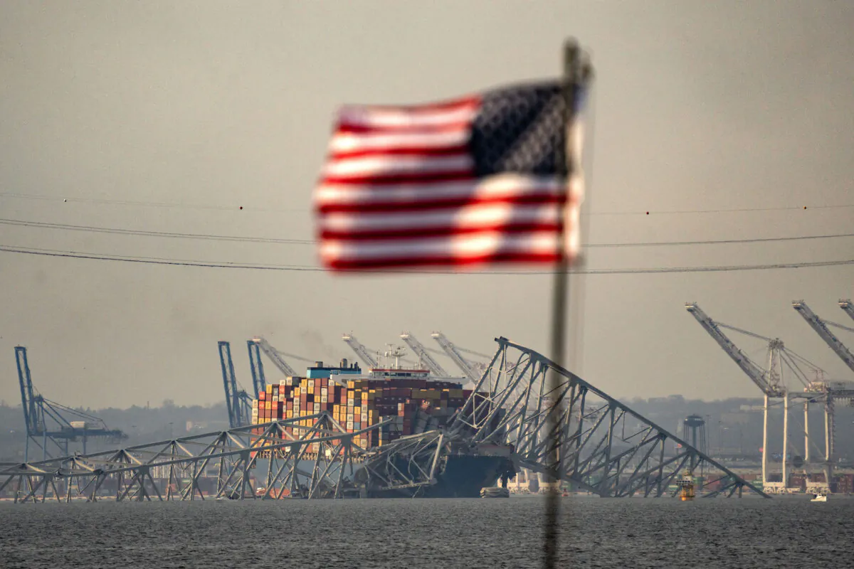 Part of the steel frame of the Francis Scott Key Bridge sits on top of the container ship Dali after the bridge collapsed in Baltimore on March 26, 2024. (Kent Nishimura/AFP via Getty Images)