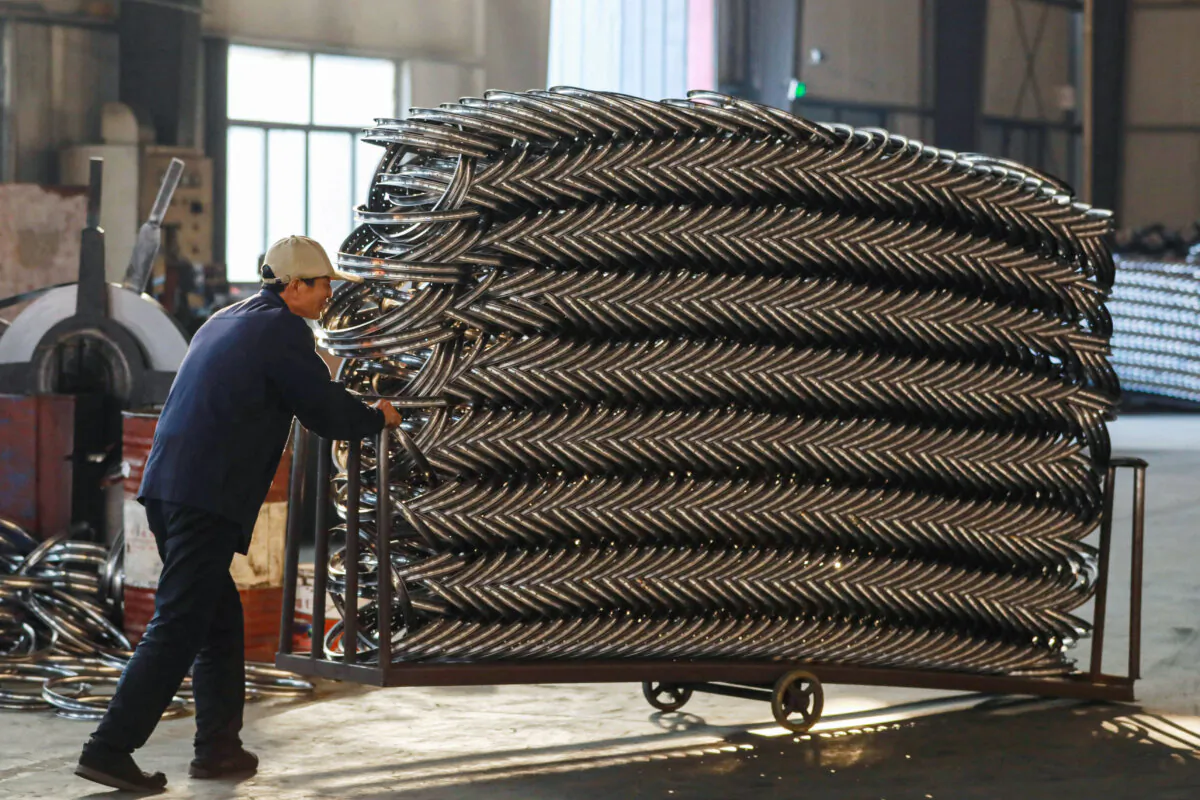 A worker pushes a cart of steel rims at a factory in Hangzhou, China, on Feb. 18, 2024. (STR/AFP via Getty Images)