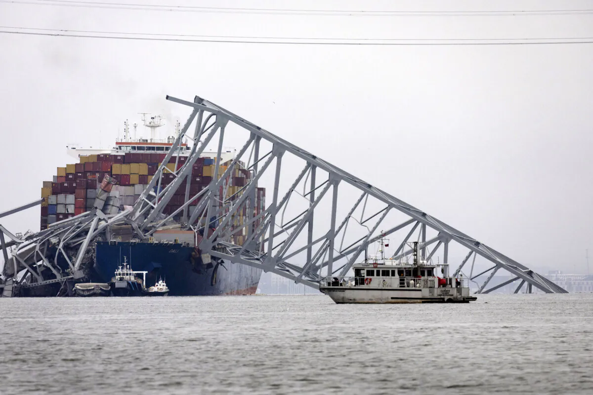 Workers continue to investigate and search for victims after the cargo ship Dali collided with the Francis Scott Key Bridge in Baltimore on March 27, 2024. The bridge collapsed a day earlier after the ship strike. (Scott Olson/Getty Images)