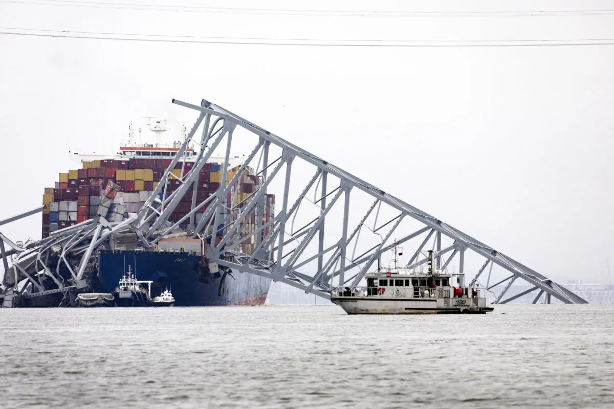 The scene after the cargo ship Dali struck the Francis Scott Key Bridge a day earlier causing it to collapse, in Baltimore, Md., on March 27, 2024. (Scott Olson/Getty Images)