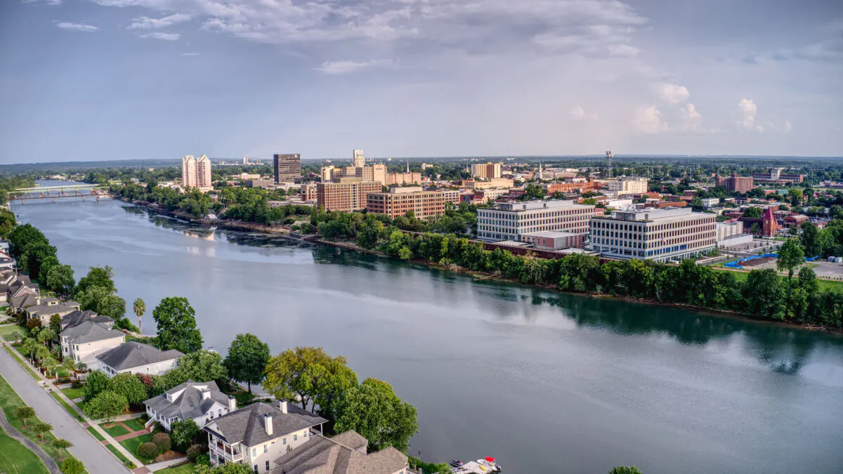 The skyline of downtown Augusta reflects in the Savannah River, the dividing line with North Augusta, S.C. (Destination Augusta/TNS)