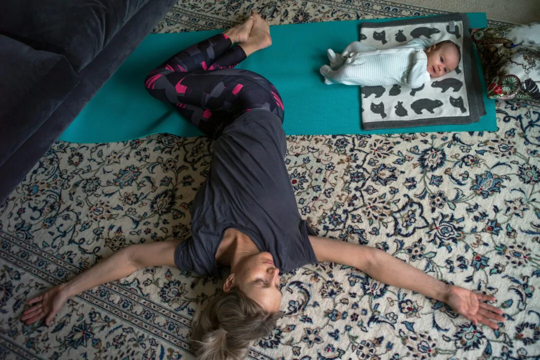 The photographer's wife and son, Katy Boaler and Leo, take part in a live streamed baby yoga class as the country continues to be locked down, in London on April 1, 2020. (Dan Kitwood/Getty Images)