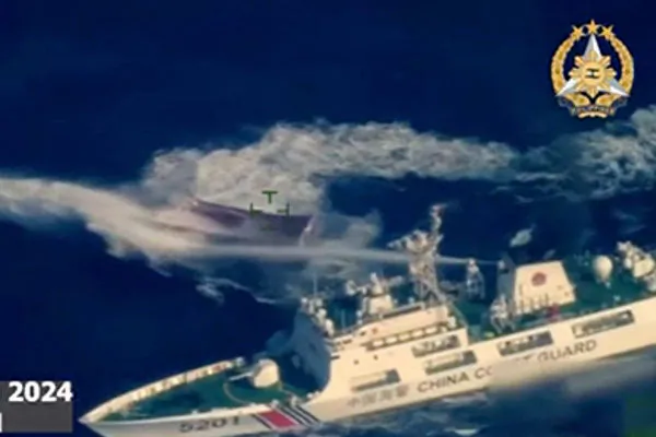 This frame grab from aerial video footage shows a China Coast Guard ship (bottom R) deploying water cannon against the Philippine navy-chartered boat during its supply mission near the Second Thomas Shoal in disputed waters of the South China Sea on March 23, 2024. (Armed Forces of the Philippines/AFP) 