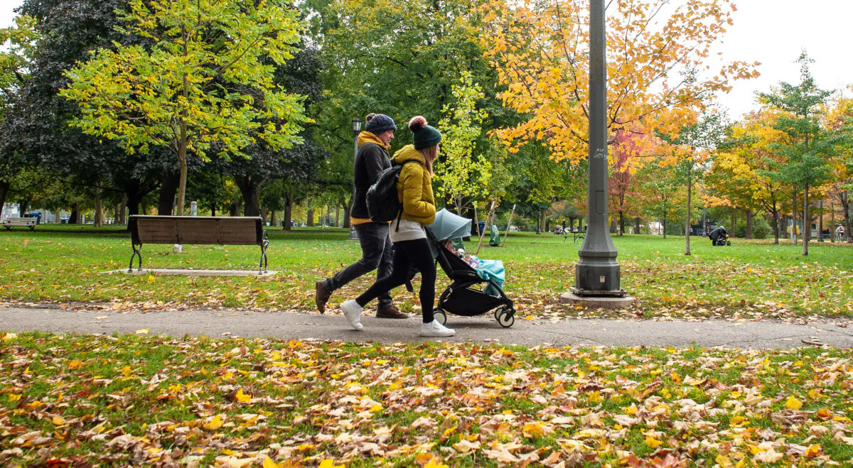 A couple pushes a stroller at Trinity Bellwoods Park, Toronto, on Oct. 28, 2021. (THE CANADIAN PRESS/Eduardo Lima)