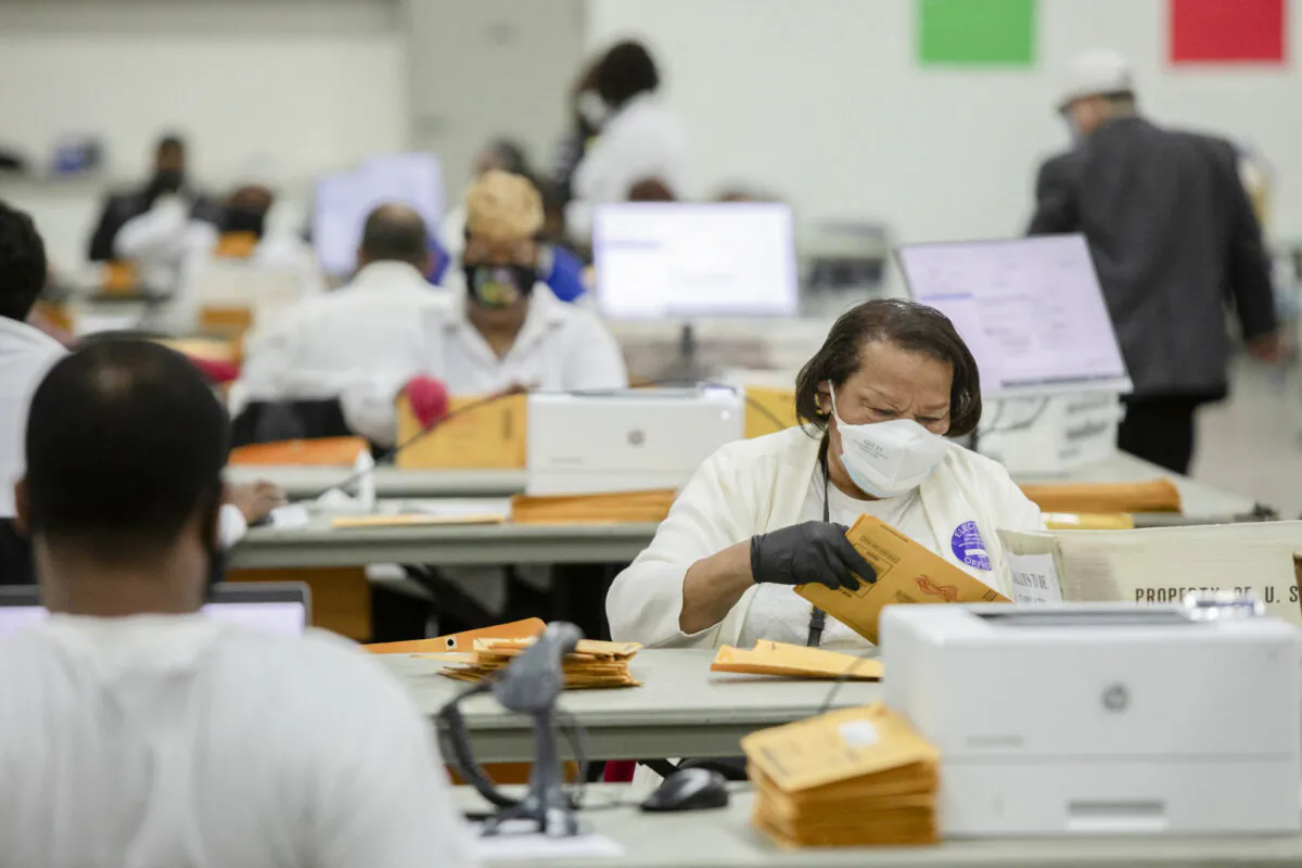 Workers with the Detroit Department of Elections sort through absentee ballots at the Central Counting Board in the TCF Center in Detroit, Mich., on Nov. 2, 2020. (Elaine Cromie/Getty Images)