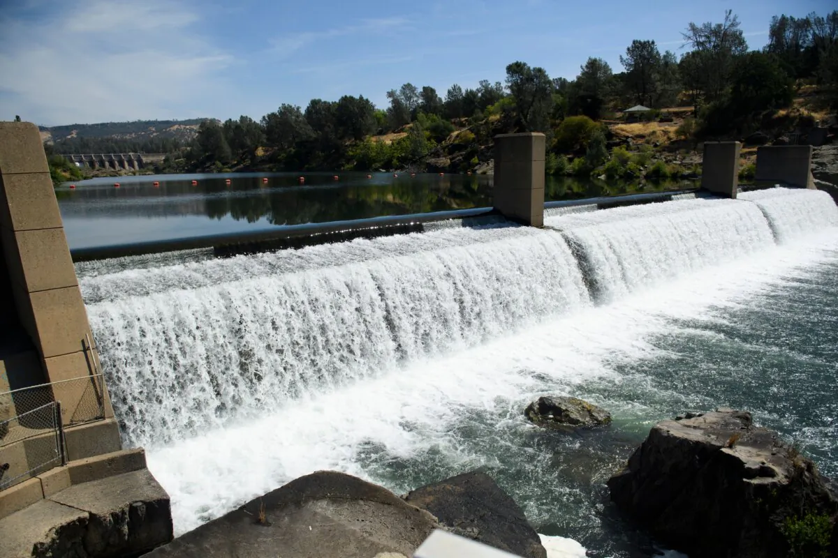 Water flows over the Feather River Fish Barrier dam as it diverts Chinook Salmon up a fish ladder to the California Department of Fish and Wildlife Feather River Hatchery below the Lake Oroville dam during the California drought emergency in Oroville, Calif., on May 27, 2021. (Patrick T. Fallon/AFP via Getty Images)