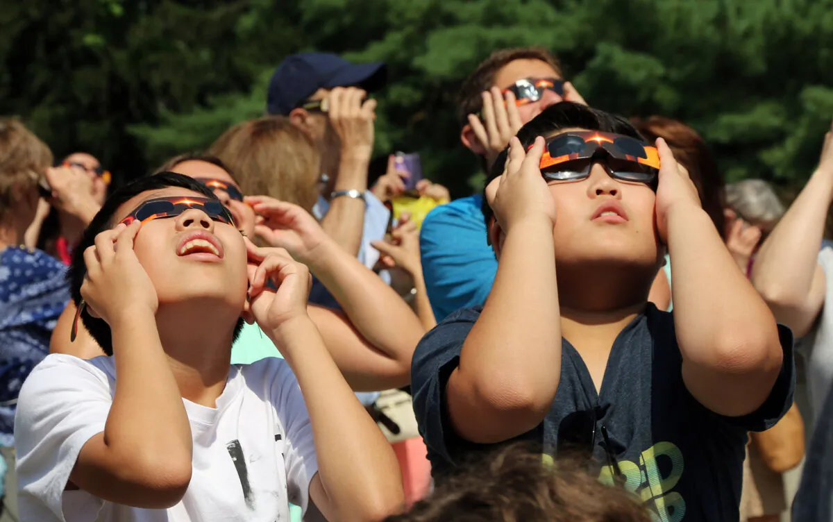Kids watching the solar eclipse with protective eye wear. (Dreamstime/TNS)