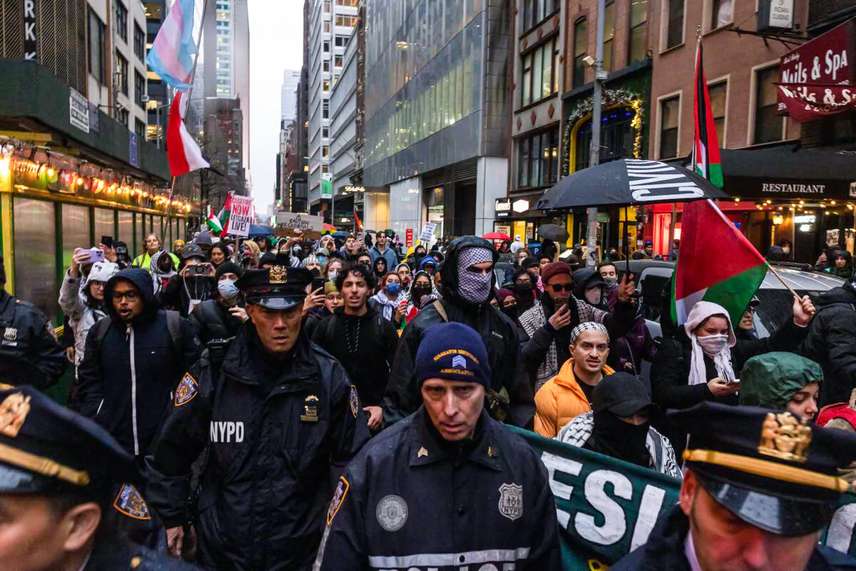 NYPD officers march alongside pro-Palestinian demonstrators near Radio City Music Hall during President Joe Biden's fundraiser in New York on March 28, 2024. (Alex Kent/Getty Images)