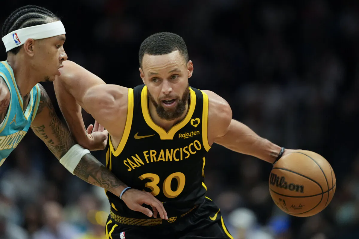 Golden State Warriors guard Stephen Curry drives to the basket past Charlotte Hornets guard Tre Mann during the first half of an NBA basketball game in Charlotte on March 29, 2024. (Chris Carlson/AP Photo)
