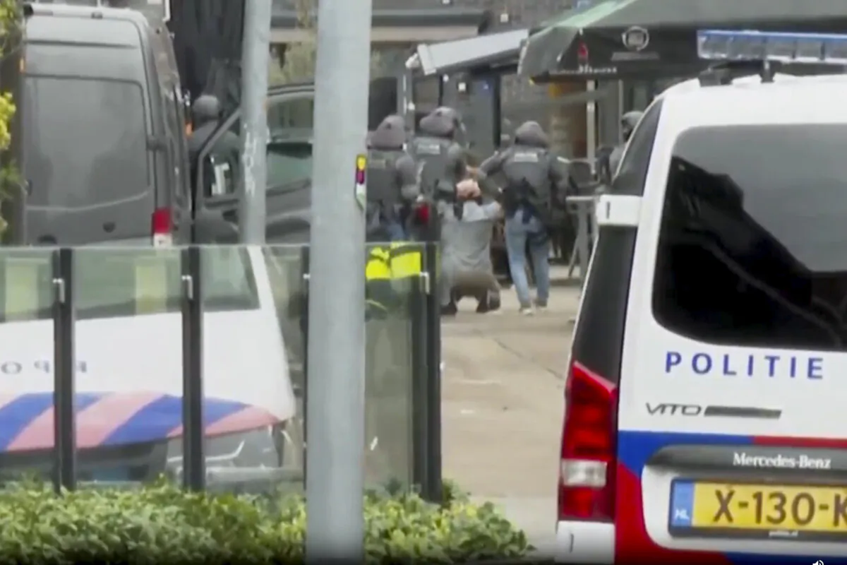This framegrab from video shows a suspected hostage-taker surrendering to police after a tense hours-long standoff in the central Dutch town of Ede, Netherlands, on March 30, 2024. (AP Photo)