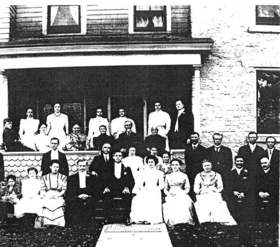 The Hem family with the 1843 house in the background.
