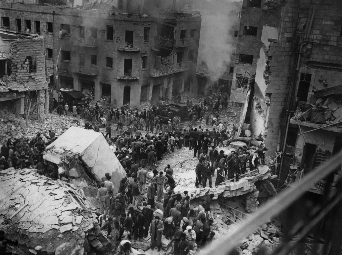 Jewish rescuers search for victims in the rubble of destroyed buildings on Ben Yehuda Street in Jerusalem in March 1948 during Arab-Israeli War, before the proclamation of the State of Israel on May 14, 1948. (Hugo H. Mendelsohn/AFP via Getty Images)