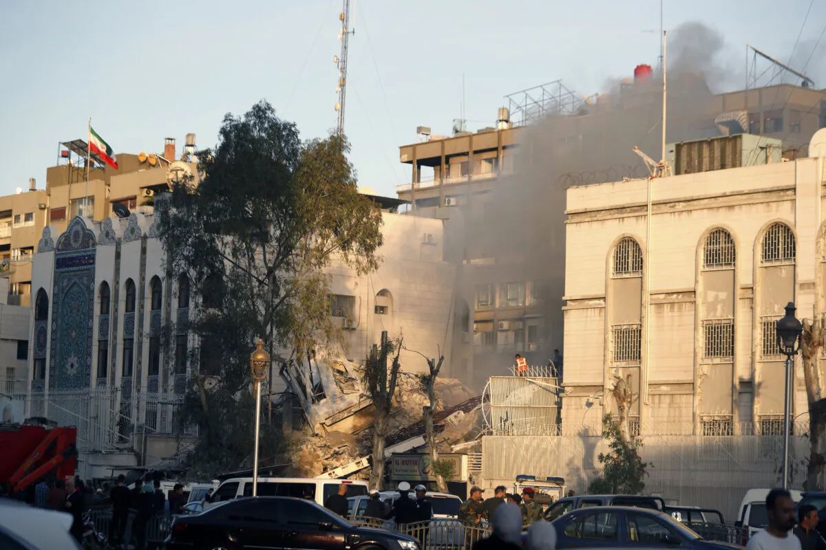 Emergency services work at a destroyed building hit by an air strike in Damascus, Syria, on April 1, 2024. (Omar Sanadiki/AP Photo)