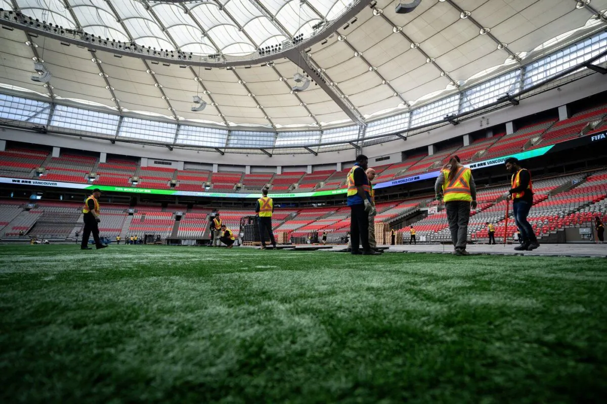 Crews work on the turf at B.C. Place during a FIFA World Cup 2026 update in Vancouver, April 30, 2024. (The Canadian Press/Ethan Cairns)

