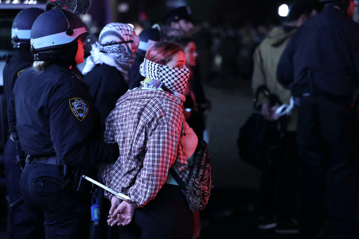 New York Police Department officers arrest students as they take them from a building that had been barricaded by pro-Palestinian student protesters at Columbia University, in New York City on April 30, 2024. (Charly Triballeau/AFP)