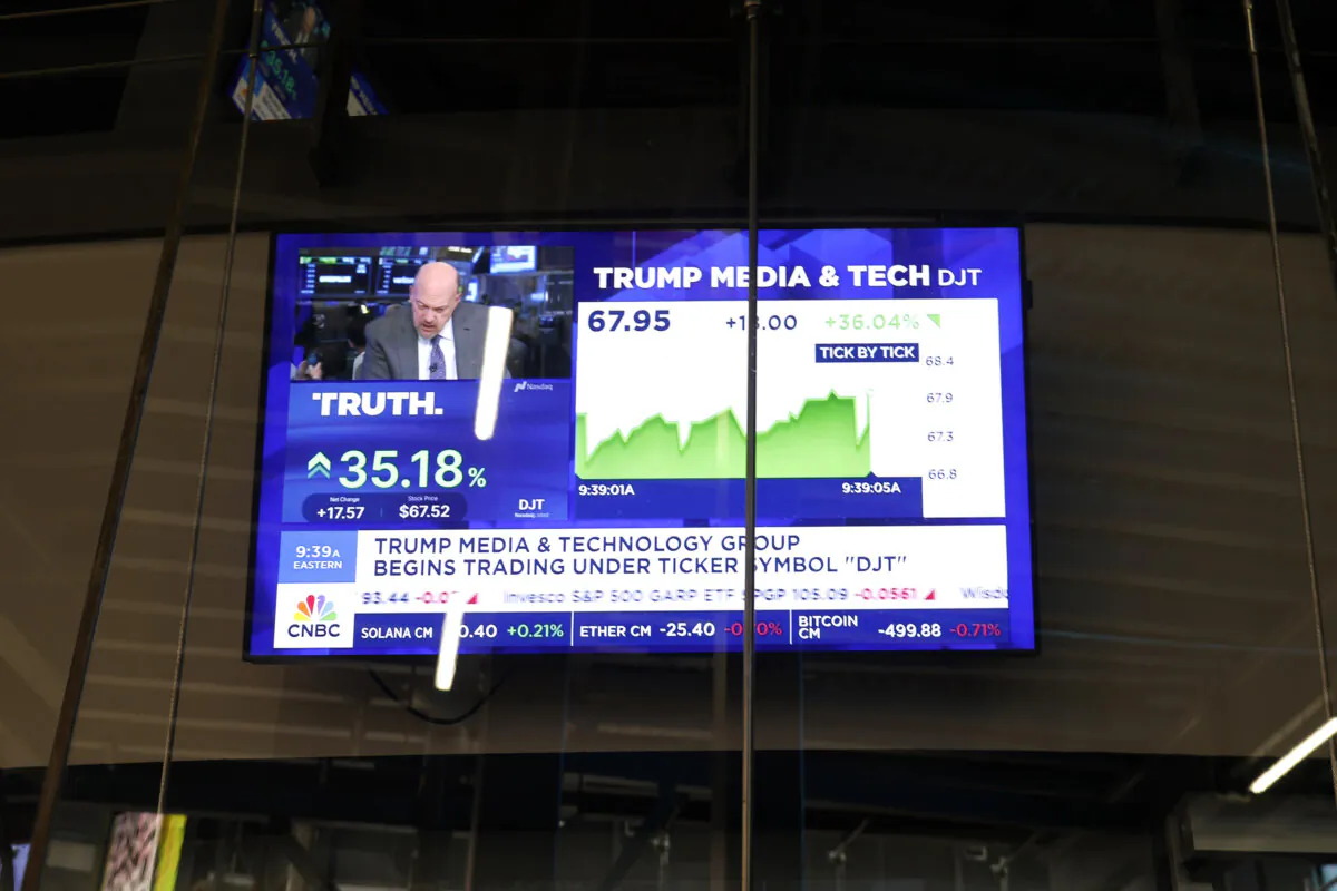 News of Trump Media & Technology Group public trading is displayed on television screens at the Nasdaq Marketplace, on March 26, 2024. (Michael M. Santiago/Getty Images)