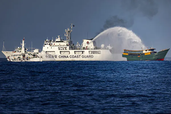 A Chinese Coast Guard ship fires a water cannon at Unaizah May 4, a Philippine Navy chartered vessel, conducting a routine resupply mission to troops stationed at Second Thomas Shoal,  in the South China Sea on March 5, 2024. (Ezra Acayan/Getty Images)