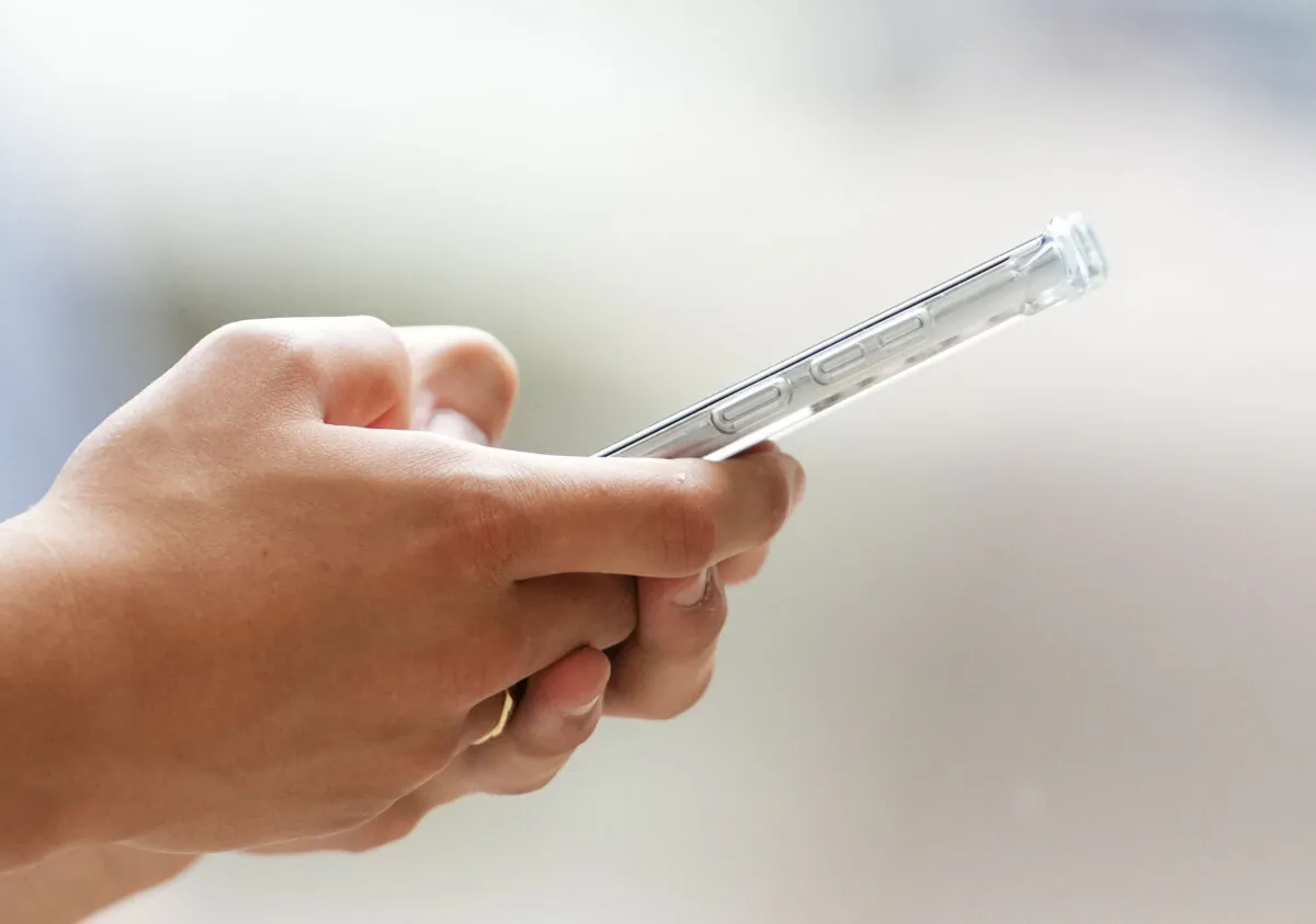A person uses a cellphone in Ottawa on July 18, 2022. (The Canadian Press/Sean Kilpatrick)