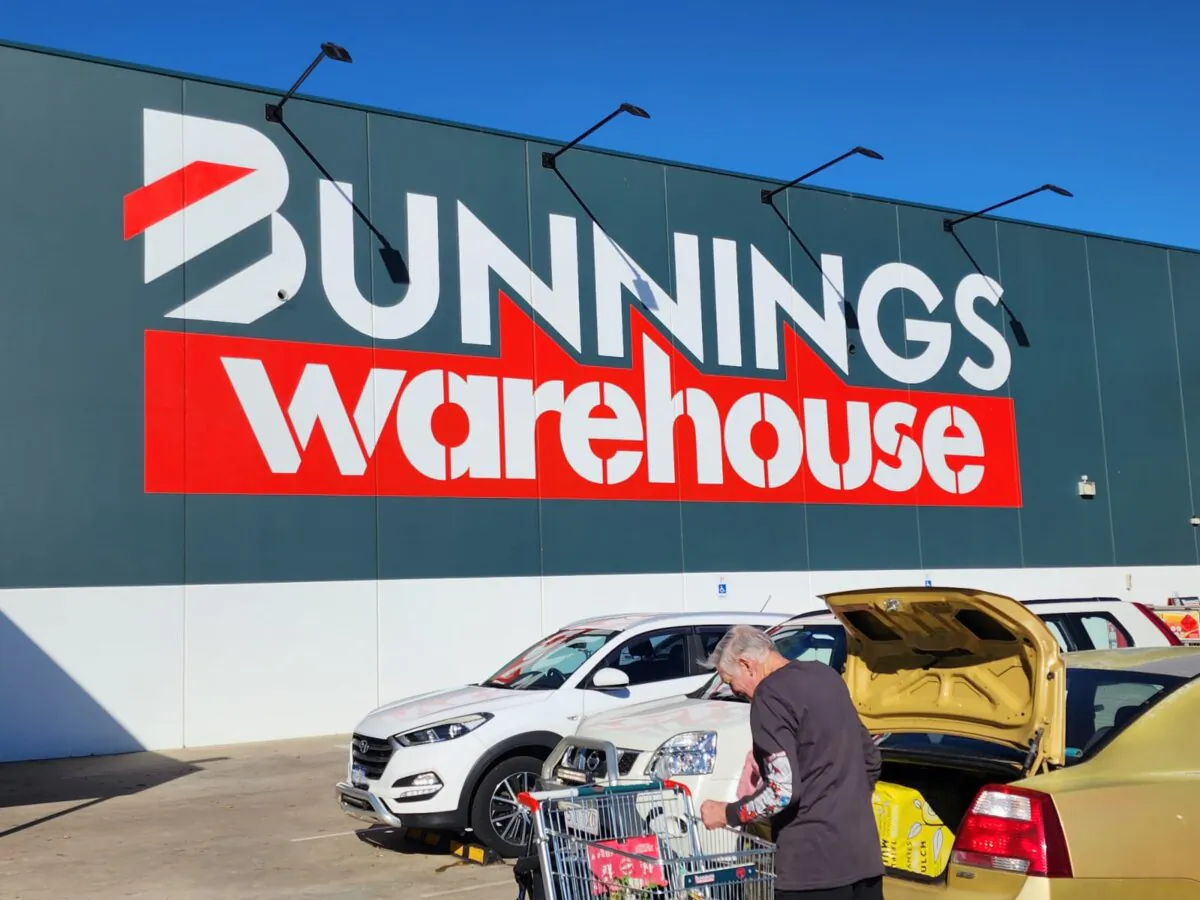 A man loads items from a trolley into a car boot at a Bunnings store in Albany, Western Australia, on April 3, 2024. (Susan Mortimer/The Epoch Times)