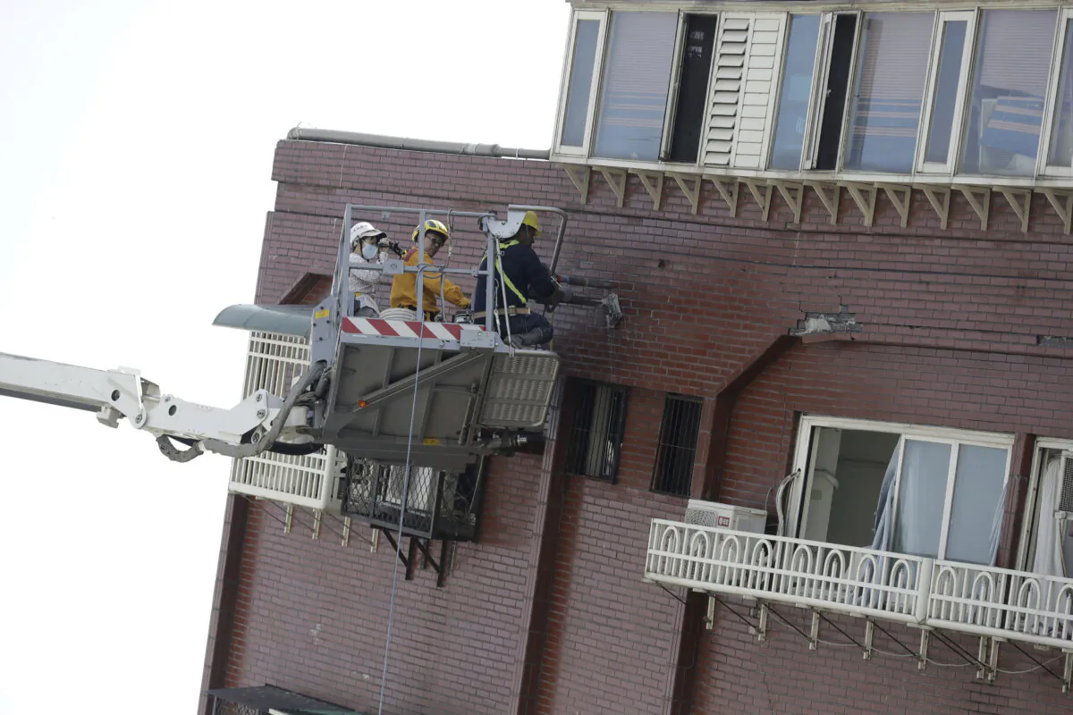 A structural engineer takes samples from a leaning building a day after a powerful earthquake struck, in Hualien City, eastern Taiwan, on April 4, 2024. (The Canadian Press/AP-Chiang Ying-ying)