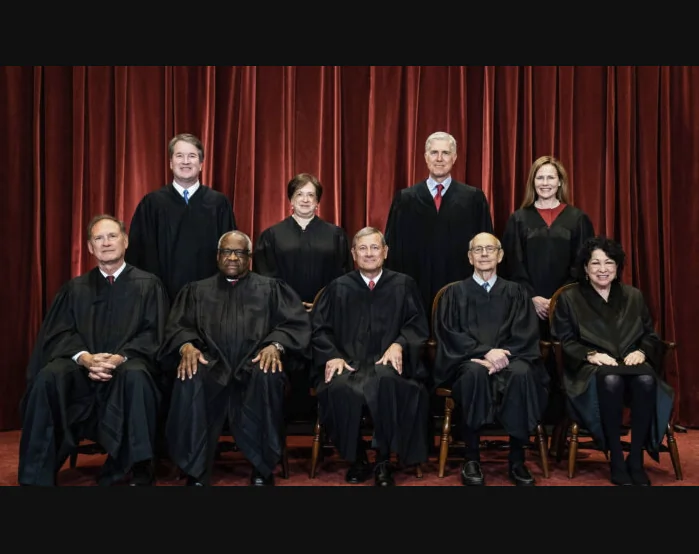 Members of the Supreme Court pose for a group photo at the Supreme Court in Washington on April 23, 2021. Standing from left: Justices Brett Kavanaugh, Elena Kagan, Neil Gorsuch, and Amy Coney Barrett. (Erin Schaff/Pool/Getty Images)