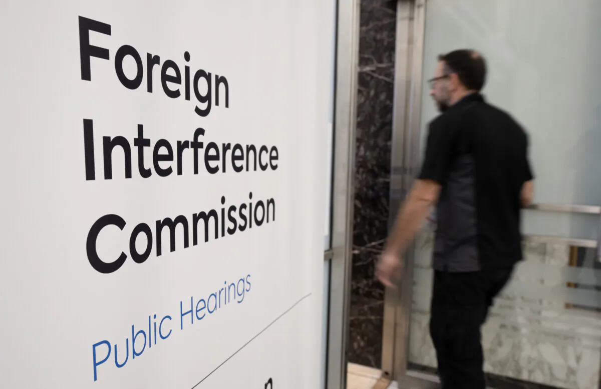 A man enters the Public Inquiry Into Foreign Interference in Federal Electoral Processes and Democratic Institutions as it begins hearings in Ottawa, on Jan. 29, 2024. (The Canadian Press/Adrian Wyld)