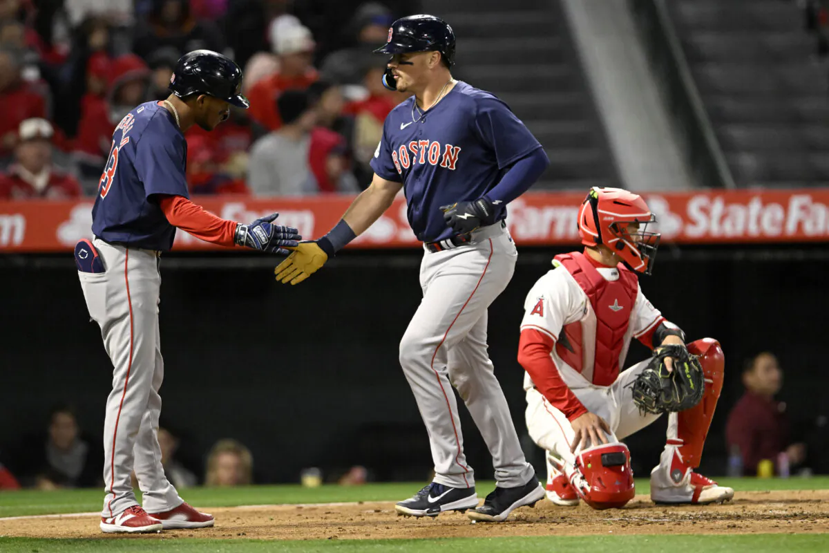 Boston Red Sox's Ceddanne Rafaela (L) greets Reese McGuire, next to Los Angeles Angels catcher Logan O'Hoppe, after McGuire hit a two-run home run during the second inning of a baseball game in Anaheim, Calif., on April 5, 2024. (Alex Gallardo/AP Photo)