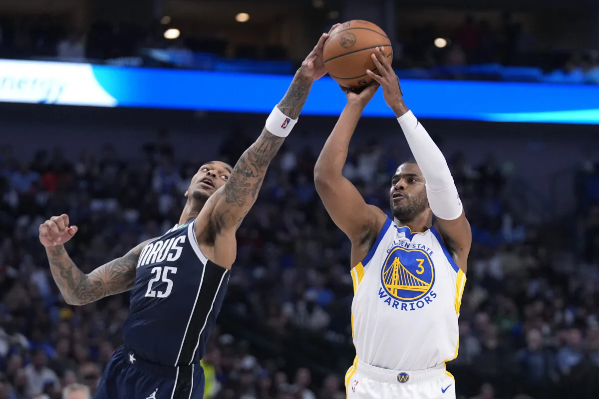 Dallas Mavericks forward P.J. Washington (25) gets a hand on the ball as Golden State Warriors guard Chris Paul (3) tries to shoot during the first half of an NBA basketball game in Dallas on April 5, 2024. (LM Otero/AP Photo)