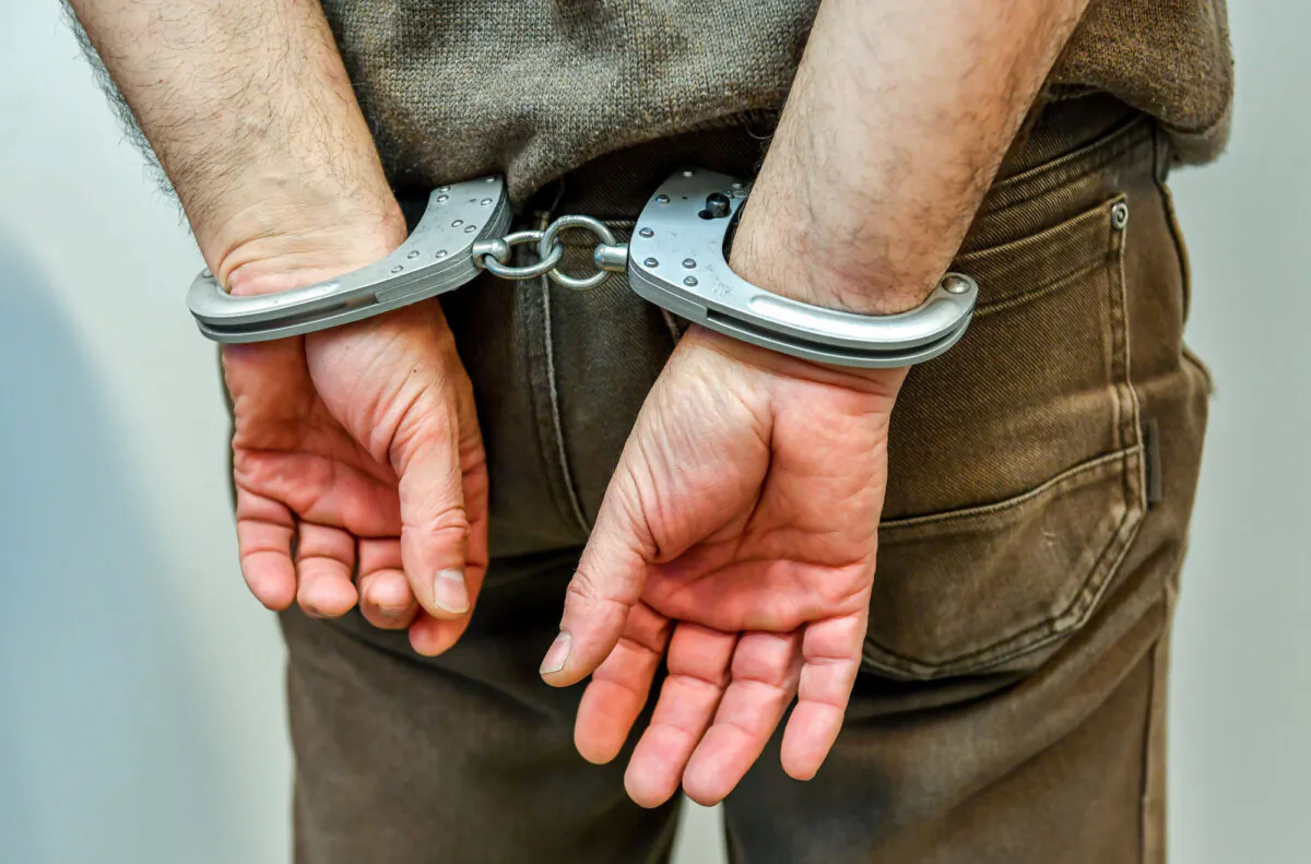 A man in handcuffs in a file photo. (Philippe Huguen/AFP/Getty Images)