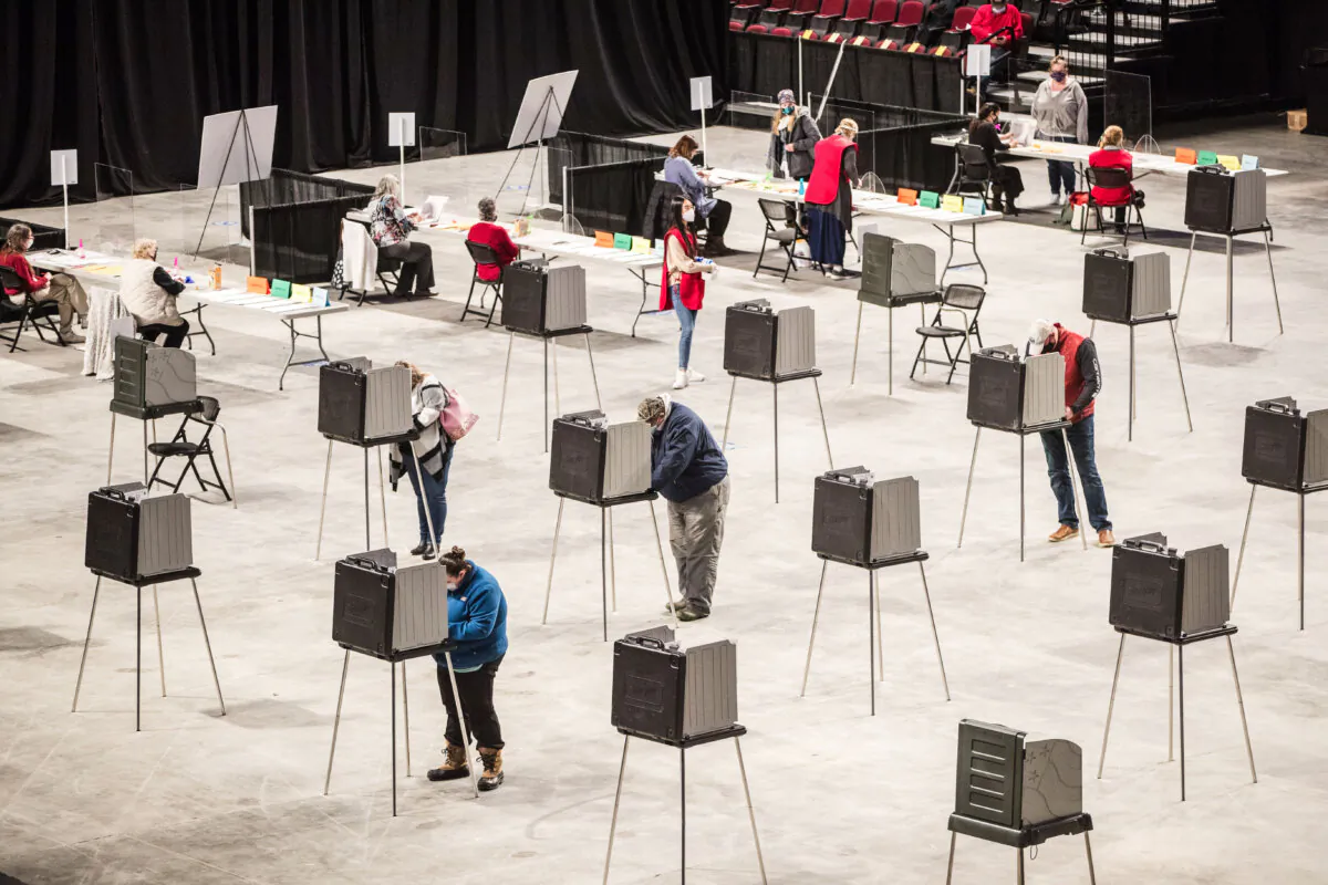 Voters fill out and cast their ballots at the Cross Insurance Center polling location where the entire city votes in Bangor, Maine, on Nov. 3, 2020. (Scott Eisen/Getty Images)