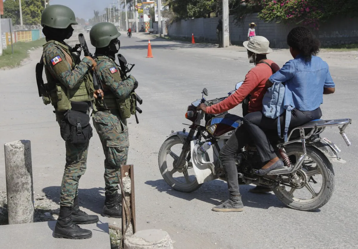 Soldiers patrol the road near the international airport in Port-au-Prince, Haiti, on March 13, 2024. (The Associated Press/Odelyn Joseph)