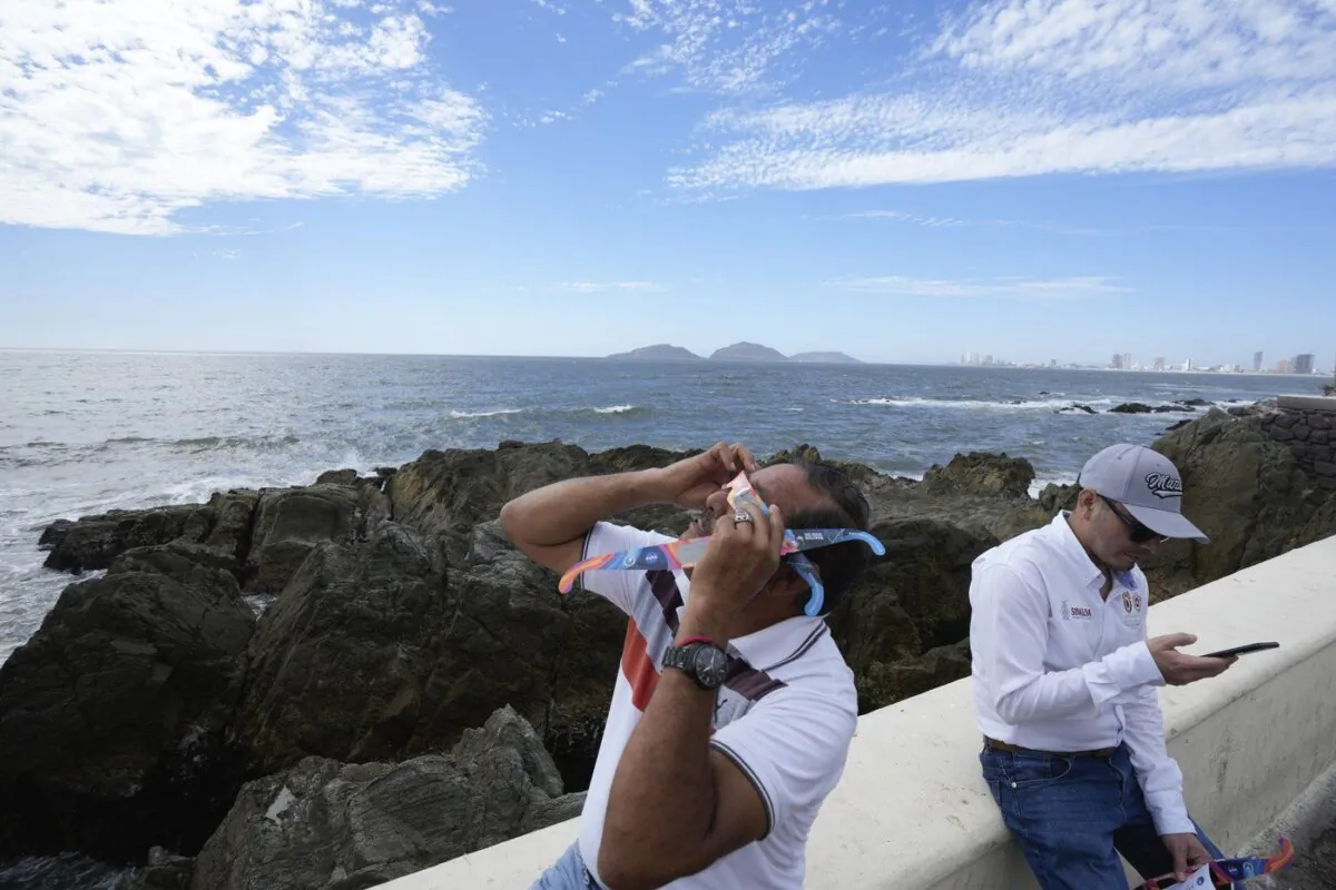A man tests special glasses in preparation for viewing an upcoming solar total eclipse in Mazatlan, Mexico, on April 7, 2024. (AP Photo/Fernando Llano)
