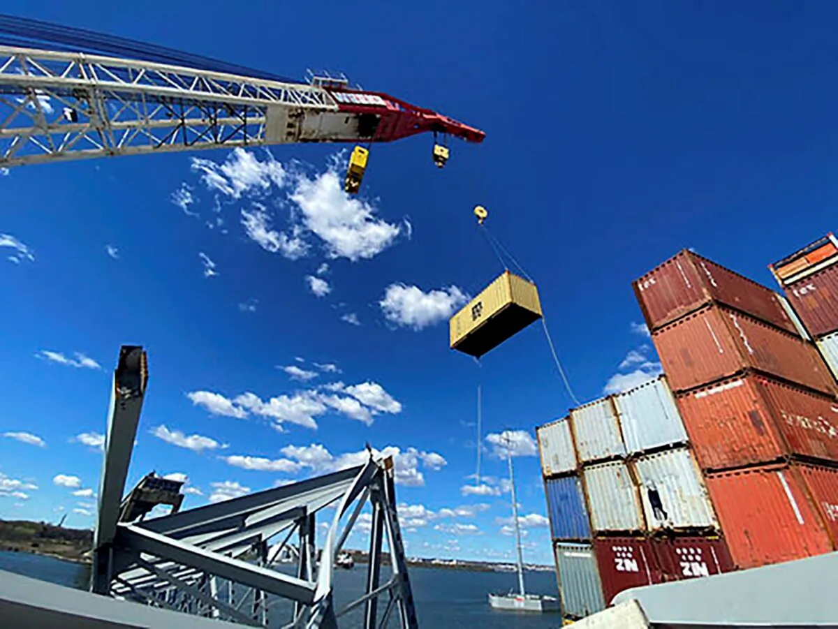 Response crews begin removing shipping containers from the deck of the cargo ship Dali using a floating crane barge at the site of the Francis Scott Key Bridge in Baltimore on April 7, 2024. (Key Bridge Response 2024 Unified Command via AP)
