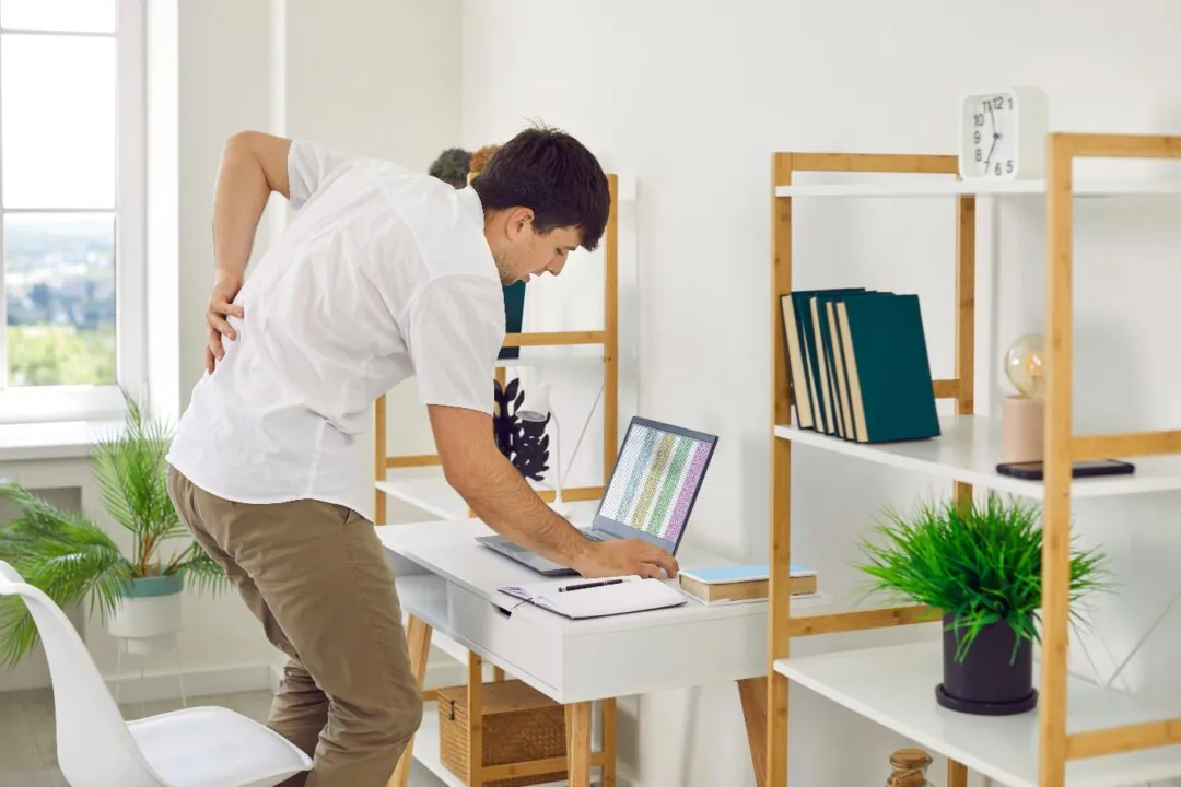 Prolonged sitting has become a major risk factor for health, potentially leading to body soreness, and in severe cases, spinal and cardiovascular issues. (Studio Romantic/Shutterstock)