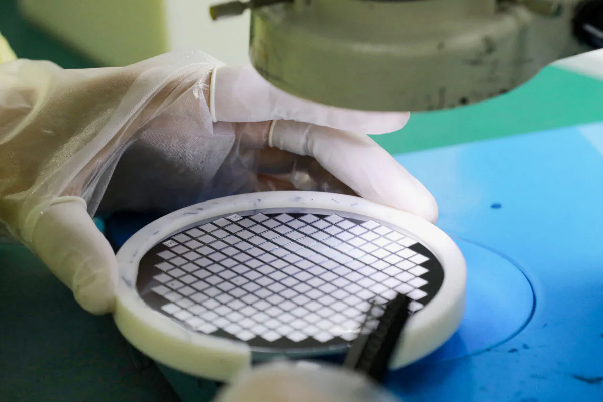 An employee makes a chip at a factory of Jiejie Semiconductor Company in Nantong, in eastern China's Jiangsu province on March 17, 2021. (STR/AFP via Getty Images)