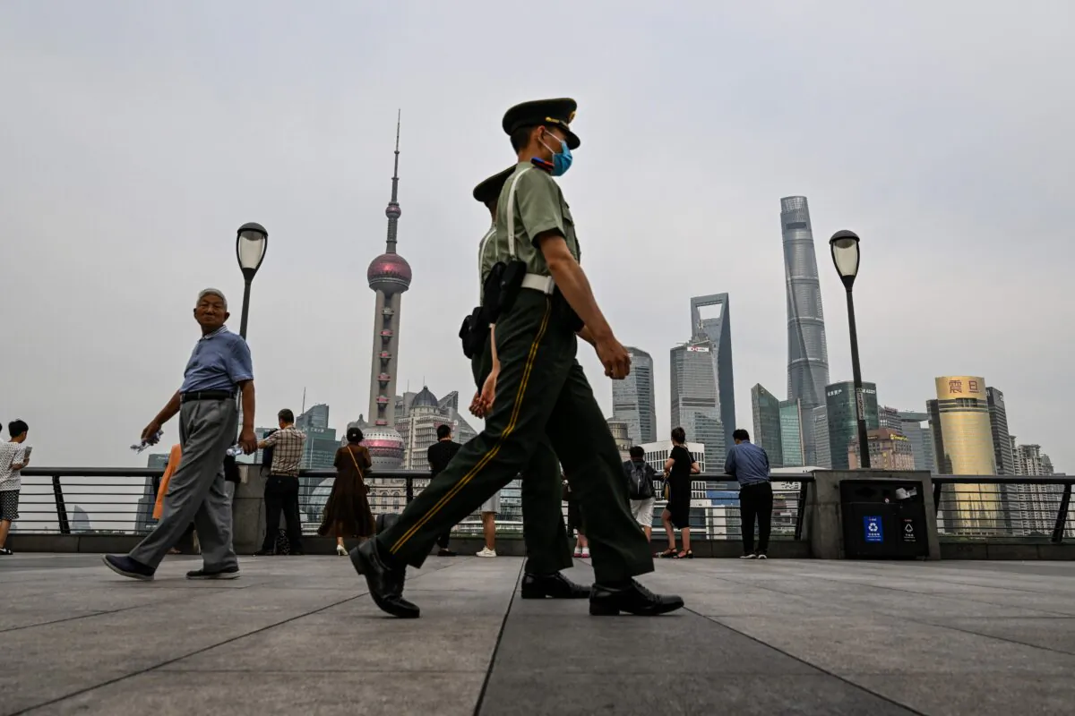 Chinese paramilitary police walk on the Bund promenade along the Huangpu river in the Huangpu district in Shanghai, China, on June 15, 2023. (Hector Retamal/AFP via Getty Images)