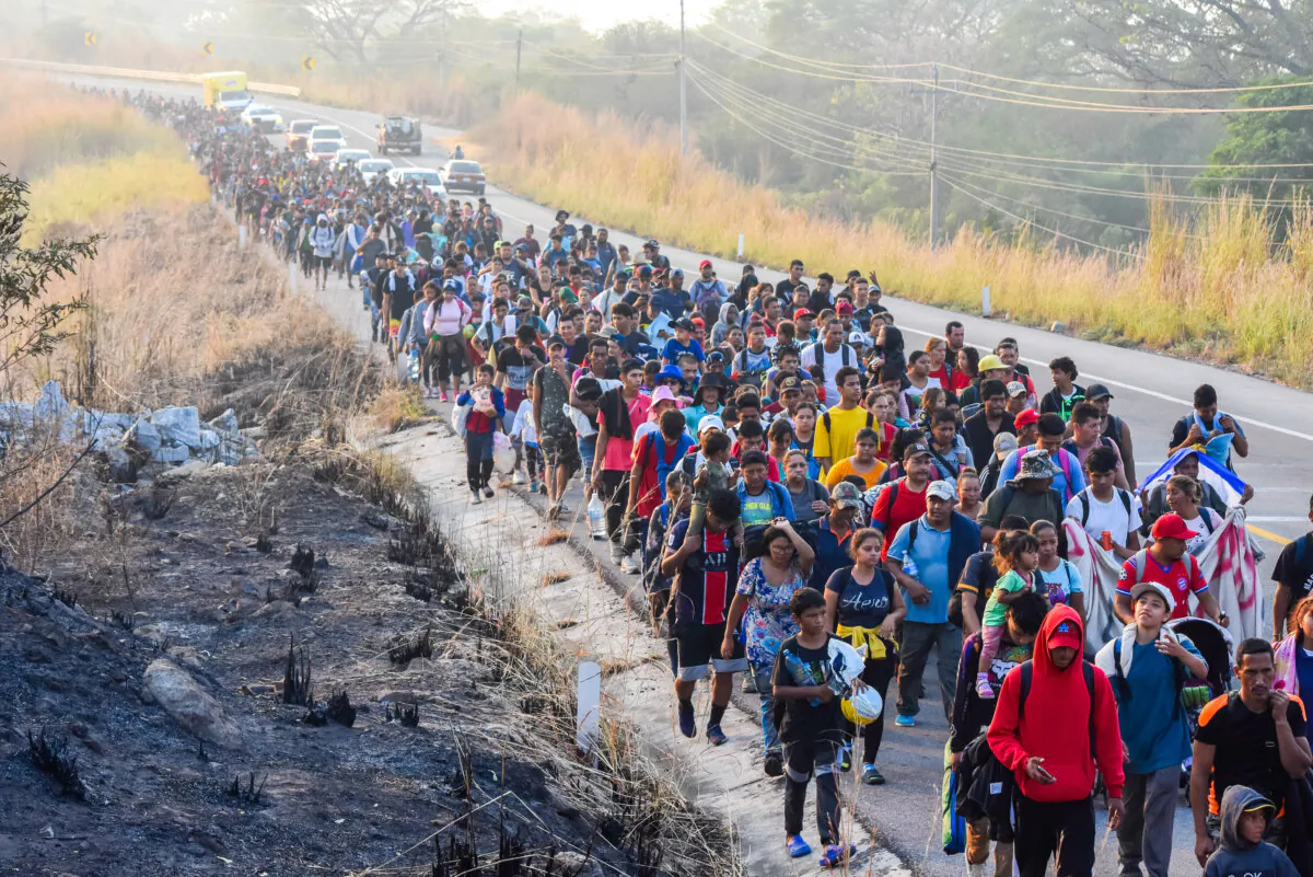 People walk along the highway through Arriaga, Chiapas state in southern Mexico, on their way to the United States, on Jan. 8, 2024. (Edgar H. Clemente/AP Photo)