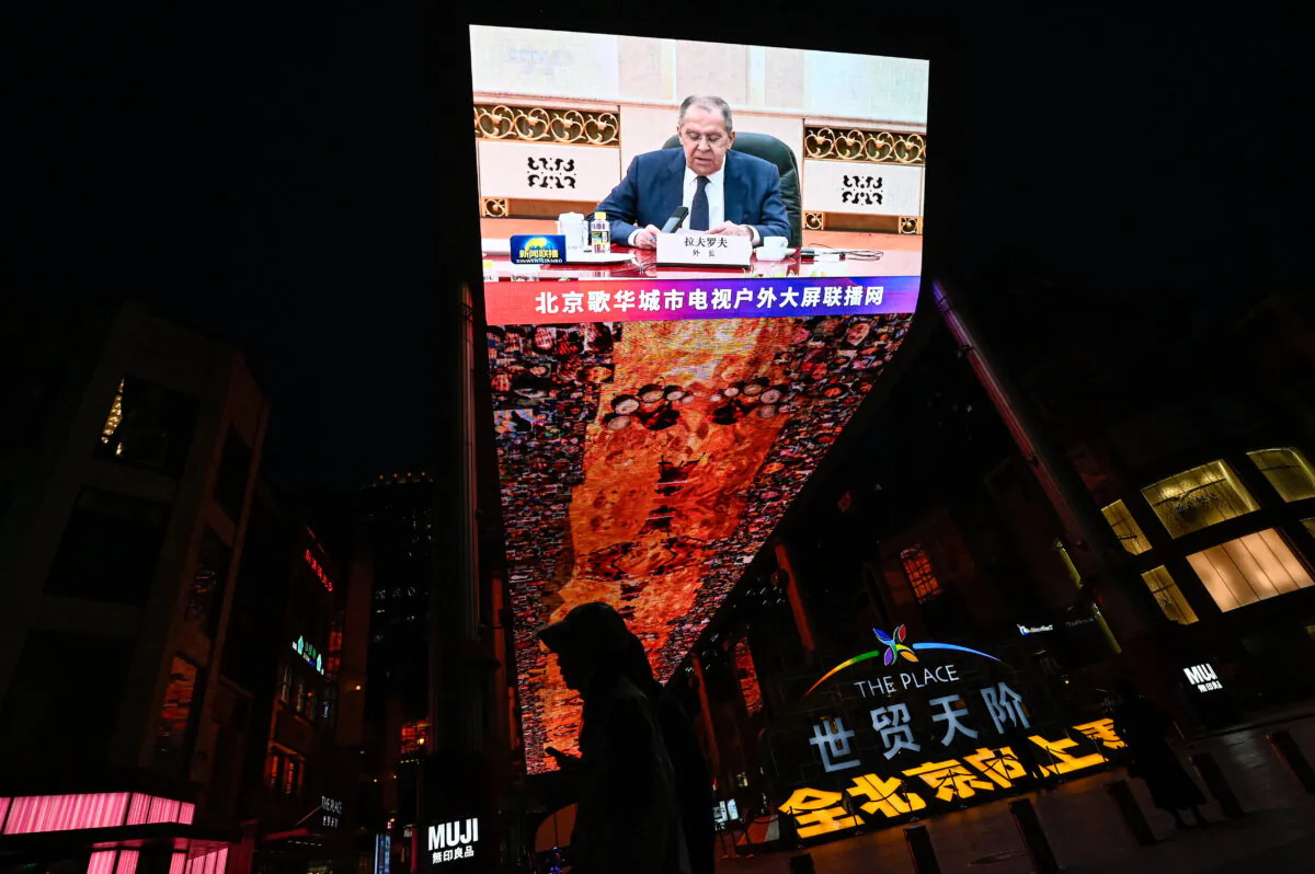 An outdoor screen shows a news coverage of Russian Foreign Minister Sergei Lavrov meeting Chinese leader Xi Jinping in Beijing on April 9, 2024. (Jade Gao/AFP via Getty Images)