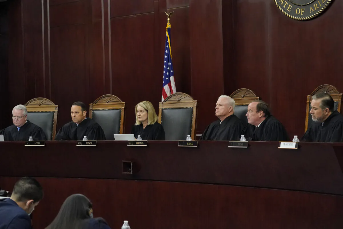 Arizona Supreme Court Justices (L–R) William G. Montgomery, John R. Lopez IV, Vice Chief Justice Ann A. Scott Timmer, Chief Justice Robert M. Brutinel, Clint Bolick, and James Beene listen to oral arguments in Phoenix, on April 20, 2021. (Matt York, File/AP Photo)