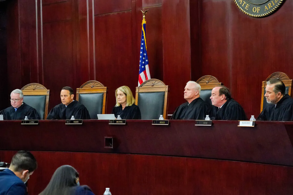 Arizona Supreme Court Justices (L–R) William G. Montgomery, John R. Lopez IV, Vice Chief Justice Ann A. Scott Timmer, Chief Justice Robert M. Brutinel, Clint Bolick, and James Beene listen to oral arguments in Phoenix on April 20, 2021. (Matt York, File/AP Photo)