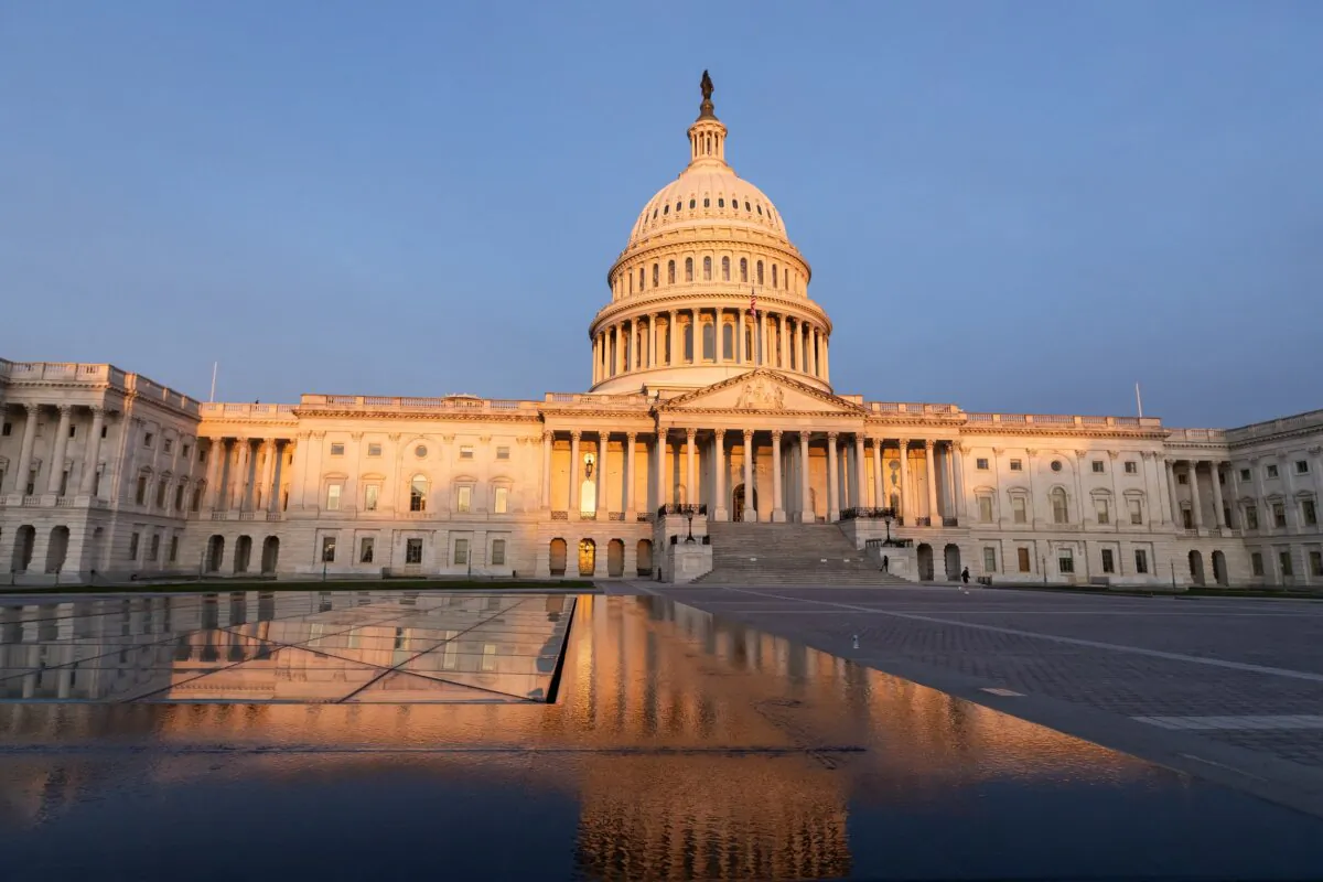 The United States Capitol is reflected by a fountain in the plaza at sunrise in Washington on March 26, 2024. (Allison Bailey/Middle East Images/AFP via Getty Images)