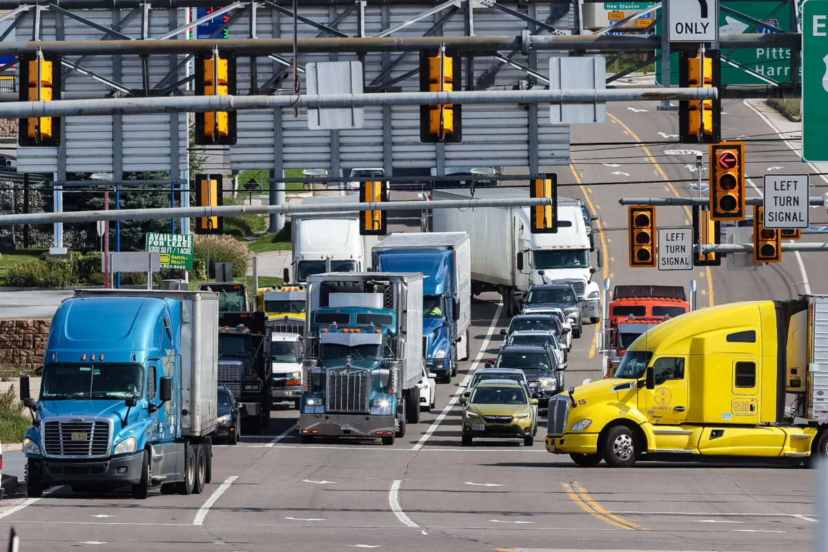Semi-trailer trucks move along the Lincoln Highway while using the indirect interchange from Interstate 70, the Pennsylvania Turnpike, and U.S. Route 30, in Breezewood, Pa., on Oct. 14, 2021. (Chip Somodevilla/Getty Images)