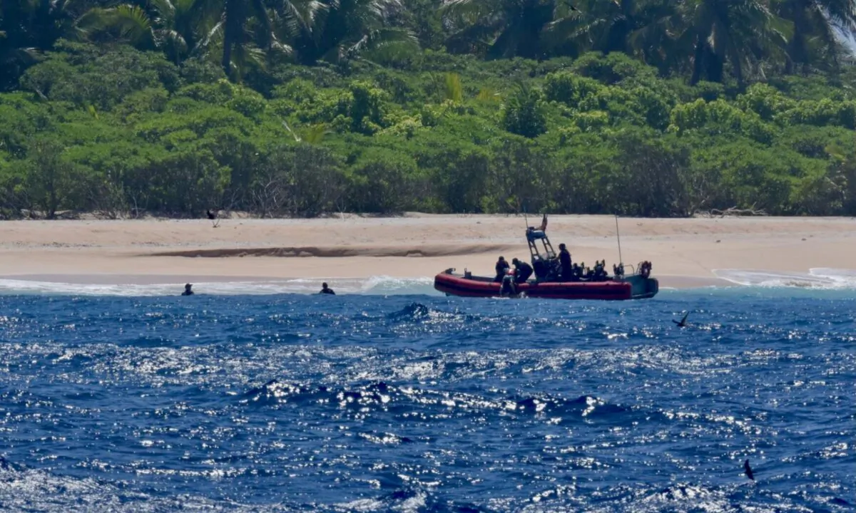 The crew of USCGC Oliver Henry rescues three mariners stranded on Pikelot Atoll, Yap State, Federated States of Micronesia, on April 9, 2024. (Courtesy of U.S. Coast Guard)
