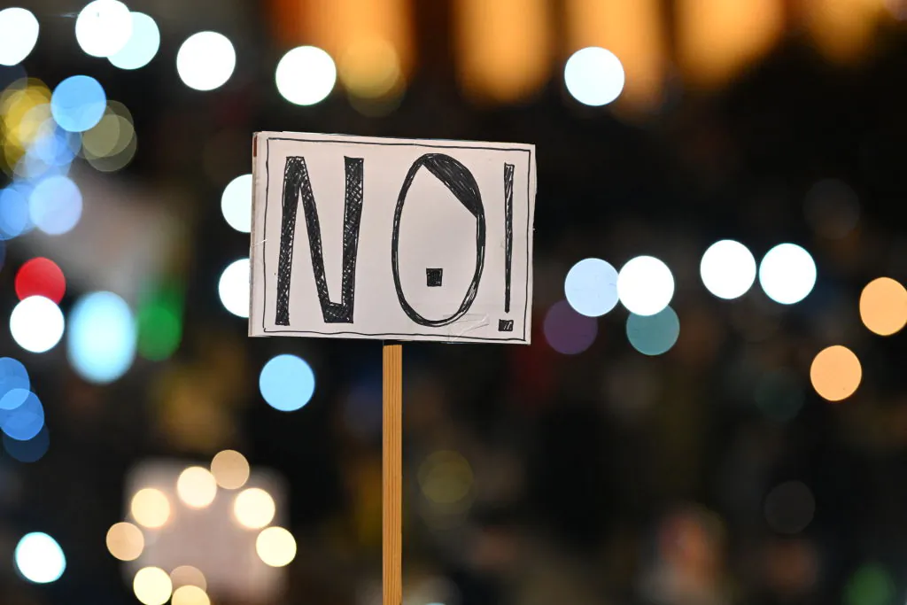A placard reading "NO! (with moustaches)" is pictured during a demonstration against racism, anti-Semitism and hate speech, named "Sea of lights for democracy" (Lichtermeer für Demokratie) at the Theresienwiese fairground in Munich, southern Germany, on Feb. 11, 2024. (Lukas Barth/AFP via Getty Images)
