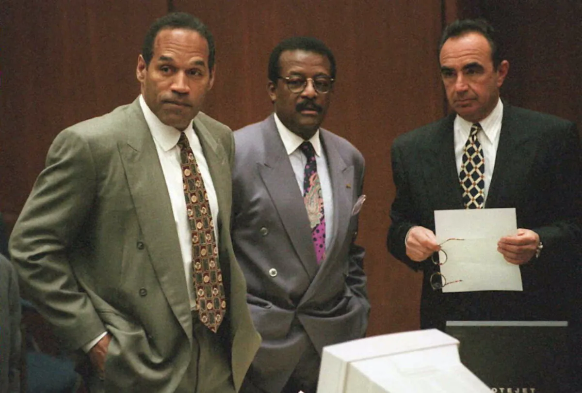 O.J. Simpson (L), Johnnie Cochran Jr. (C) and Robert Shapiro (R) watch the jury come into the courtroom on May 9, 1995 during the O.J. Simpson murder trial in Los Angeles. (Rick Meyer/AFP via Getty Images)